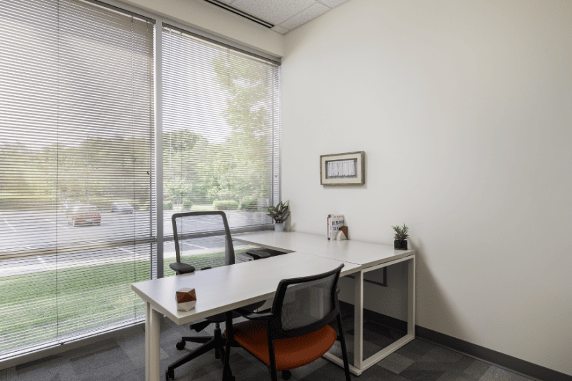 Modern office space with large window and minimal decor for productivity.