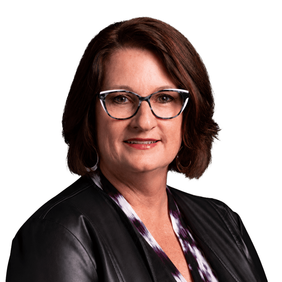 Professional woman with glasses smiling in a business setting.